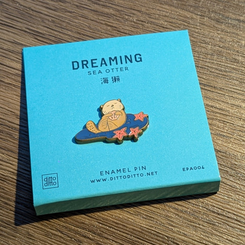 dreaming - sea otter enamel pin