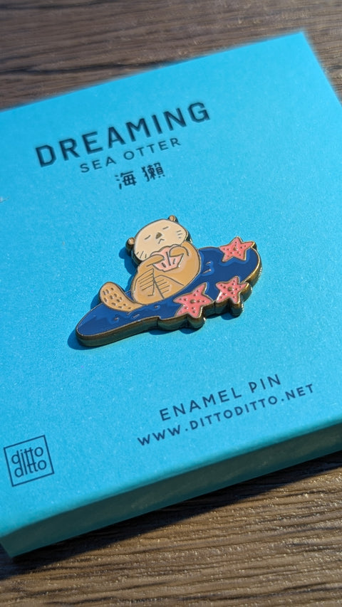 dreaming - sea otter enamel pin